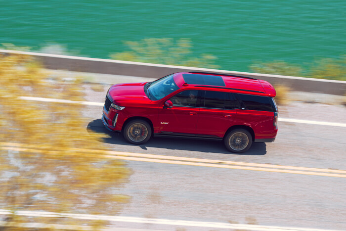 The 2023 Cadillac Escalade-V in motion as it drives down a highway.